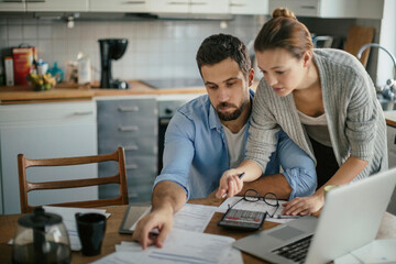 Young couple reading bad financial report having financial debt at home - obrazy, fototapety, plakaty