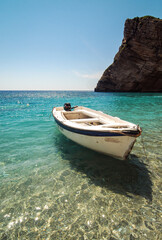 Boat on Chomi beach known as Paradise beach near Palaiokastritsa village on Corfu Island, Greece