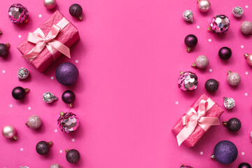Christmas tree balls with gifts on pink background