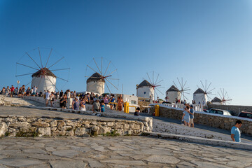 Fototapeta na wymiar Lots of people at the windmills in Mykonos