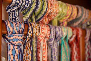 Many colorful belts with patterns. Folk art, handmade, Knitting of a traditional ethnic latvian folk belt