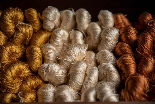 Colorful silk threads for weaving in a textile factory , Cotton color natural dyes handmade, old weaving loom and thread of yarn