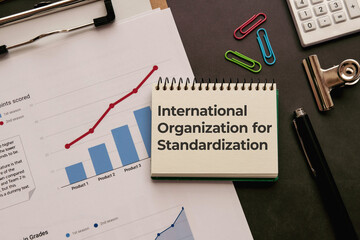There is notebook with the word International Organization for Standardization. It is an abbreviation for International Organization for Standardization as eye-catching image.