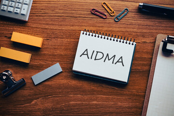 There is notebook with the word AIDMA. It is an abbreviation for AIDMA as eye-catching image.