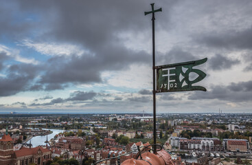 Polish ensign on the top of the tower of Saint Mary Church on Old Town of Gdansk city, Poland