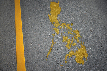 yellow map of philippines country on asphalt road near yellow line.