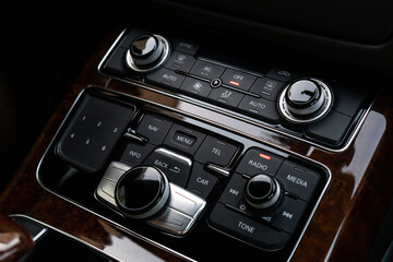 Interior of modern luxury car. Details of automatic transmission gear shift, multimedia control...