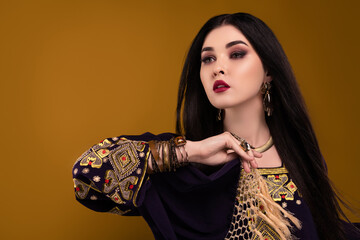 Photo of gorgeous pretty lady hold national arabian scarf dancing for rich royal sultan party over...