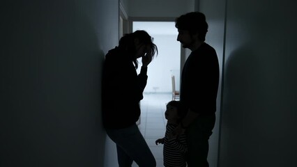 Wife suffering from mental illness standing in dark hallway. Husband embracing woman showing love and support during depression. People caring for each other