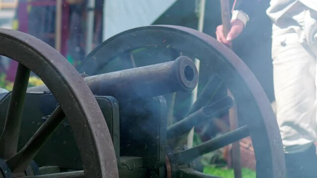Ancient Warfare: Troops Igniting antique Cannon in Historic Display