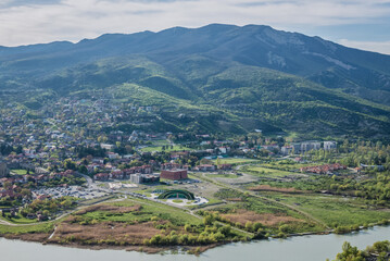 Aerial view from Orthodox Jvari Monastery on Jvari Mount on Mtskheta town, Georgia. Modern police station on foreground
