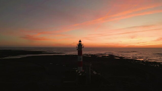 Beautiful sunset behind the historic Faro del Toston traditional lighthouse near El Cotillo and Corralejo in Fuerteventura Canary Islands Spain