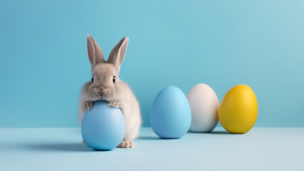 Fototapeta na wymiar Cute Easter rabbit with blue and yellow eggs on blue background