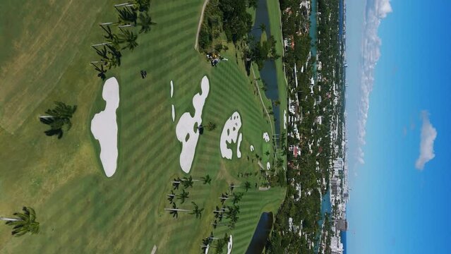 Aerial view of La Gorce Club, high-class resort and most exclusive country club in South Florida. Wonderful summer landscape of luxury golf courses. Vertical video