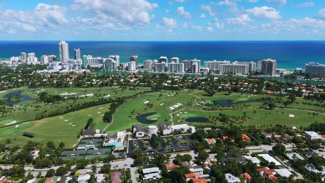 Drone view of impressive La Gorce Club surrounded with rich housing estates and villas. Private resort in green waterfront landscape with golf courses and lakes in Miami