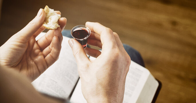 Woman taking communion - bread and wine. Christian faith and practice concept