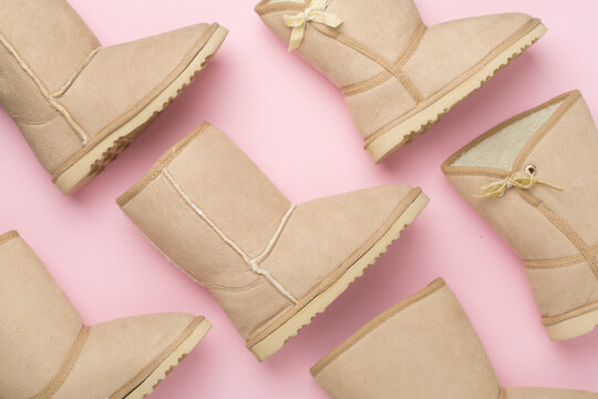 Many woman ugg boots on color background,top view
