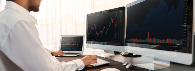 Stock trading investor monitoring dynamic financial data graph for profitable trade. Businessman or broker with analytic thinking analyzing data for stock market exchange trading company. Trailblazing