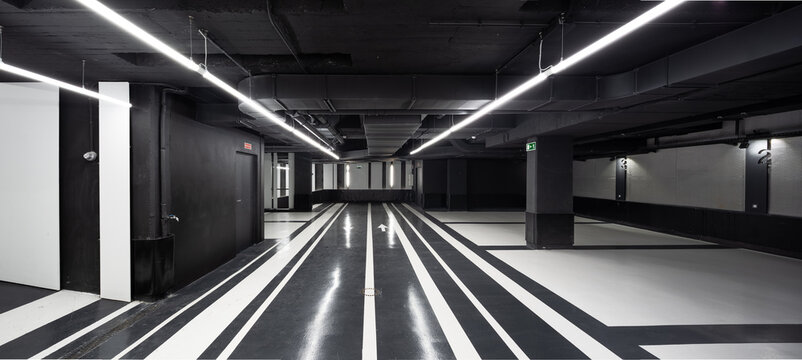 Spacious illuminated hallway with black and white floor