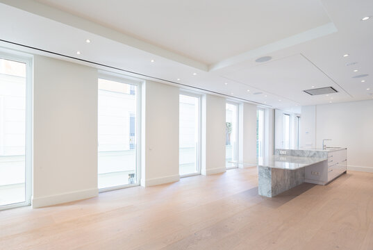 Modern kitchen with marble island and bright windows