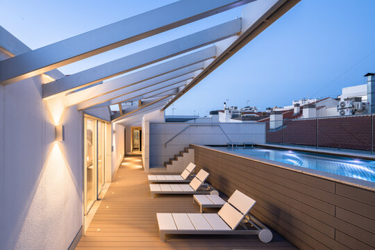 Terrace with chairs and swimming pool