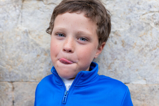 Blue eyed boy looking at the camera with a funny face