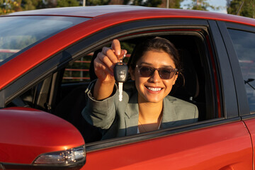 Confident businesswoman giving key during sunset
