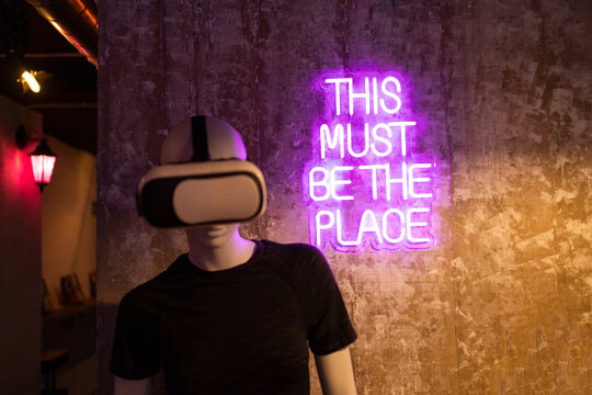 Mannequin with VR Headset in Neon-Lit Room