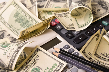 Fototapeta premium Paper money dollar banknotes, pen, pencil and calculators