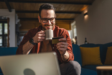 One man caucasian male online shopping use laptop and hold credit card