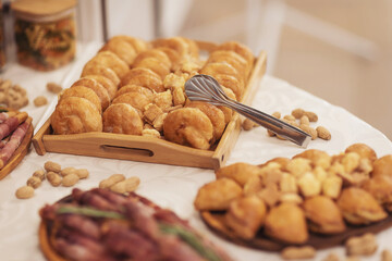 Snacks for the holiday, catering. Various snacks. Catering plate. Assortment of sandwiches on the buffet table. Prosciutto Crudo, Parma ham, meat, buns, nuts, cheese, of celebration of important event