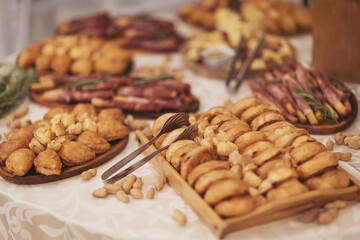 Snacks for the holiday, catering. Various snacks. Catering plate. Assortment of sandwiches on the buffet table. Prosciutto Crudo, Parma ham, meat, buns, nuts, cheese, of celebration of important event