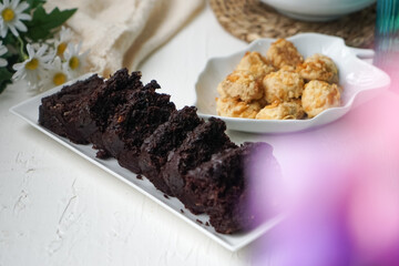 Chocolate moist cake with nuts and cornflakes cookies.