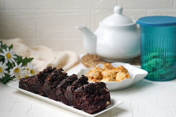 Chocolate moist cake with nuts and cornflakes cookies.