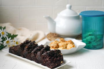 Chocolate moist cake with nuts and cornflakes cookies.