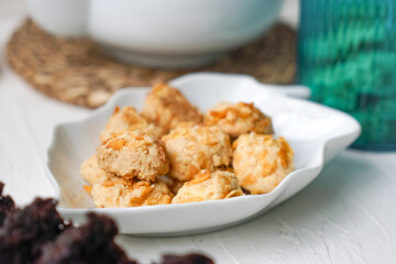 Cornflakes cookies in a white plate. Selective focus.