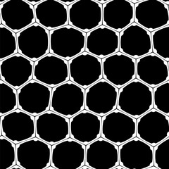 A seamless abstract pattern in bold black and white featuring a honeycomb motif on a black background with a mesh-like design