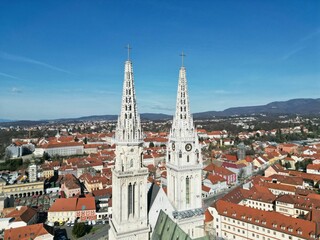 Fototapeta premium Aerial view of Zagreb City featuring two prominent steeples perched atop its skyline