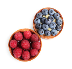 Tartlets with different fresh berries isolated on white, top view. Delicious dessert