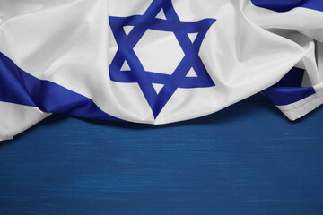 Flag of Israel on blue wooden background, space for text. National symbol