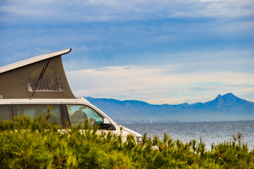 Van camper with tent on roof top camp on nature - obrazy, fototapety, plakaty