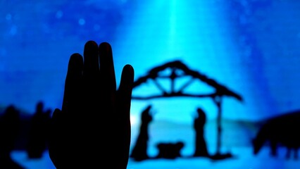 Silhouette hand raising, blurred background