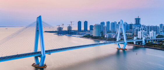 High angle dusk scenery of Century Bridge over Haidian River in Haikou, Hainan, China