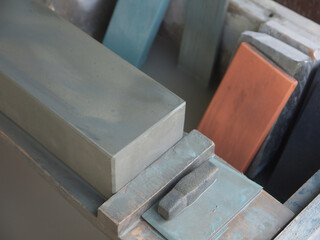 Wooden box with Old Japanese Sharpening Whetstones of different sizes and colors in workshop close up, ara-to, rough stone, naka-to or medium and shiage-to or finishing stone