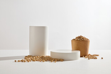 Cylinder and round podiums arranged with a wooden bowl of soybeans. Geometric shapes podium for...