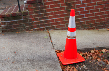 orange construction cones line the urban street, symbolizing safety, progress, and urban...