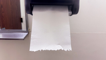 white paper towels on a bathroom countertop, reflecting cleanliness and hygiene in a modern setting