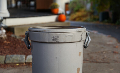 trashcan surrounded by litter in urban setting, highlighting environmental pollution and neglect