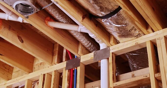 Installs insulation, plumbing system, electrical wires, ceiling light for new house before plasterboard