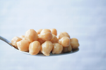 Boiled chickpeas on a spoon closeup 